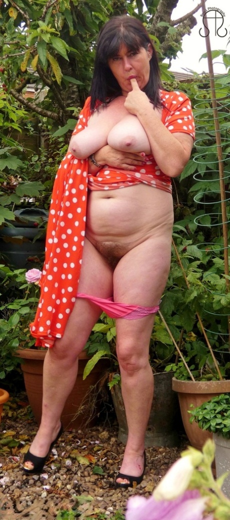 Busty UK lady Juicey Janey displays her full bush while reading a book 44581784